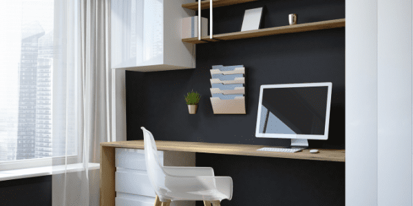 home office desk with black wall and hanging organizers